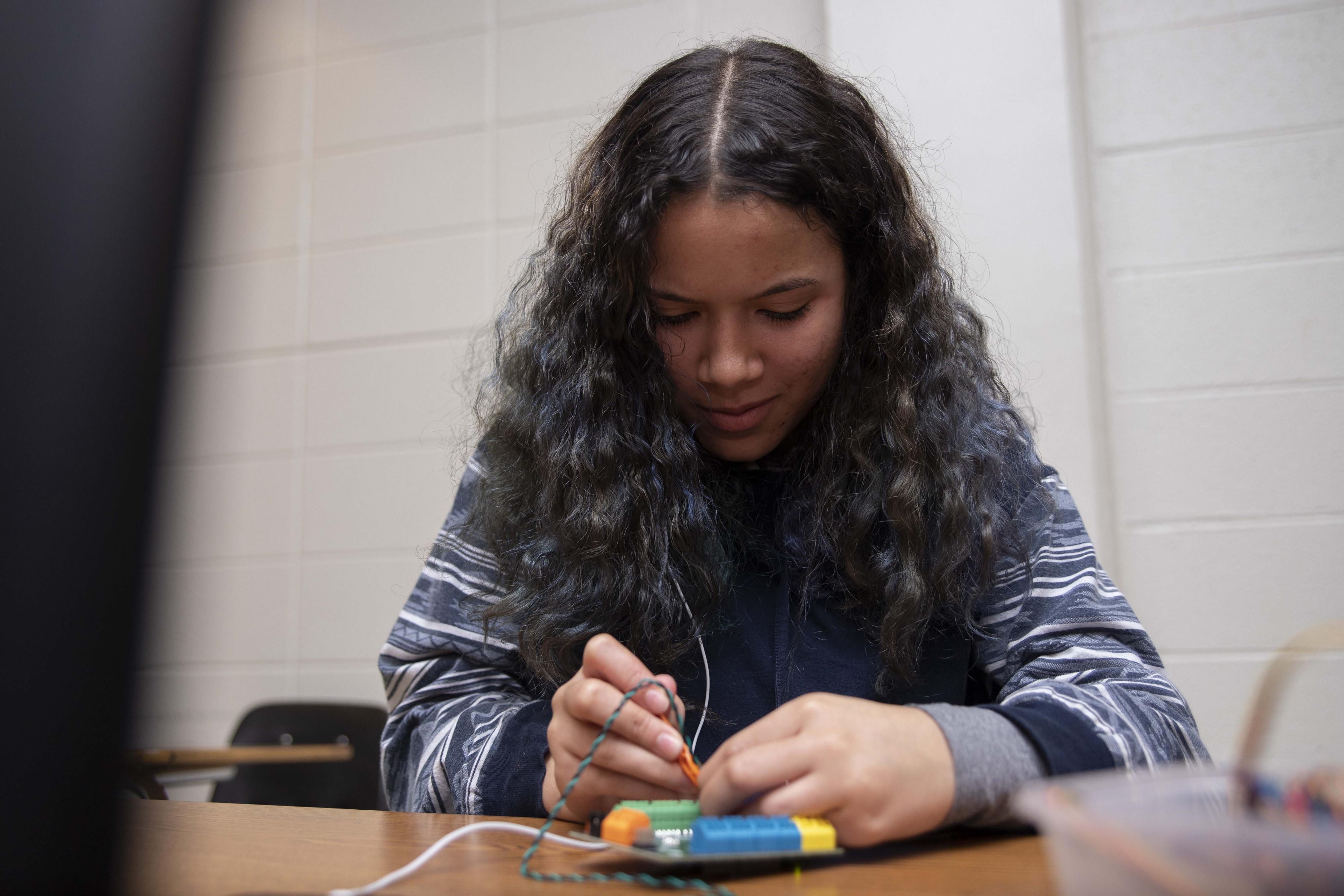 girl working on STEM activity