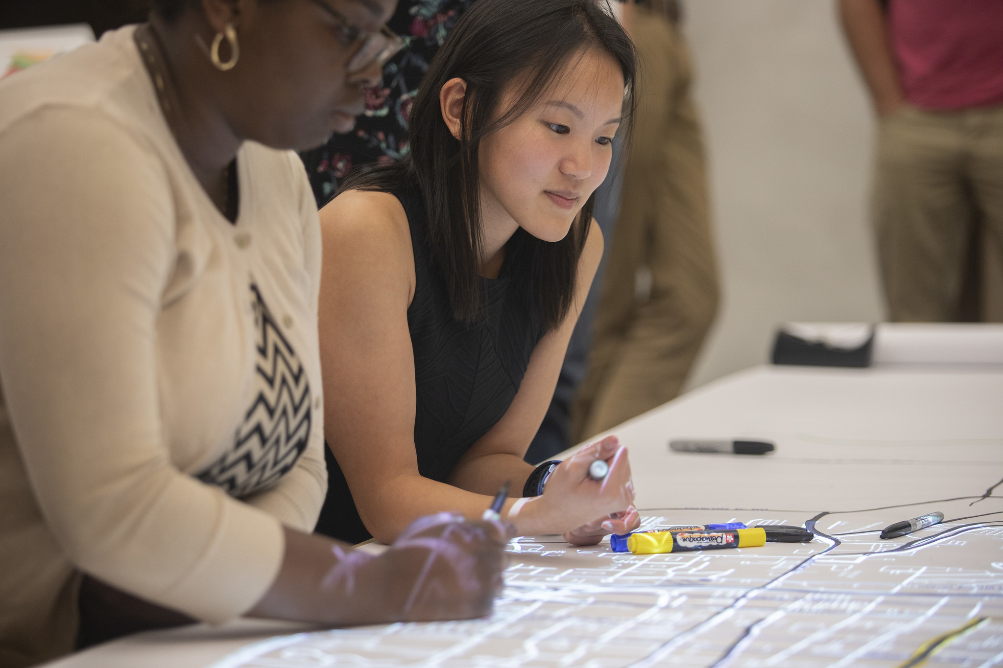 Students look over map.