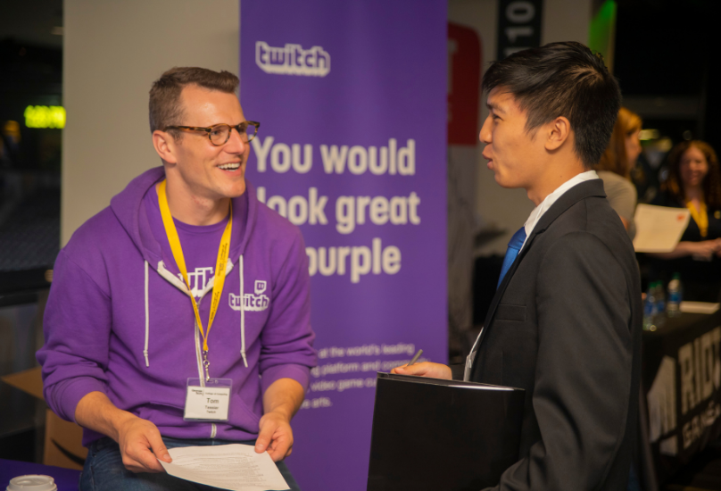 recruiter speaking with student at career fair