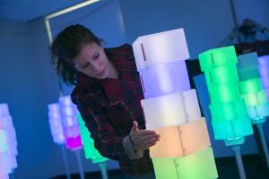 girl playing with lit up cubes