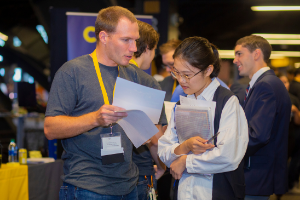 recruiter speaking with student at career fair