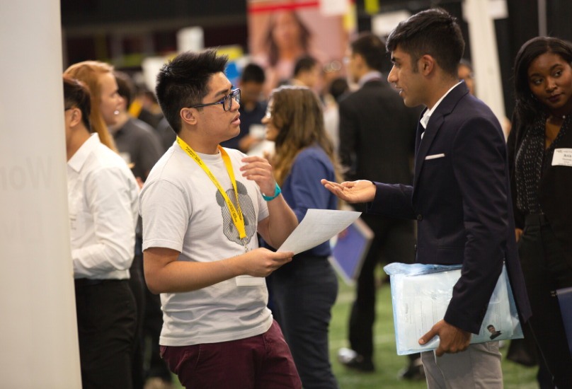 recruiter speaking with student at career fair