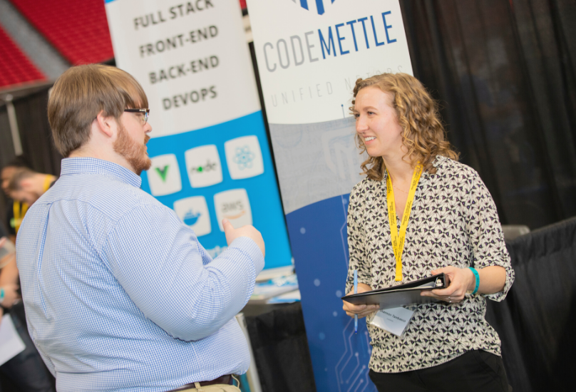 recruiter speaking with student at career fair