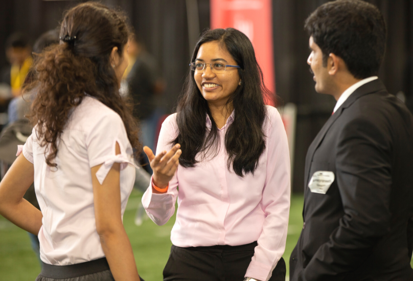 students talking at career fair