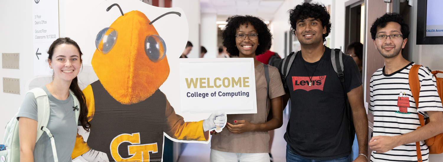 Students with Buzz and a sign that says "Welcome"