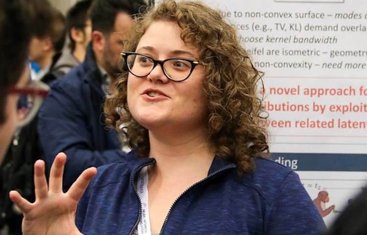 a Georgia Tech female grad student during a conference poster session