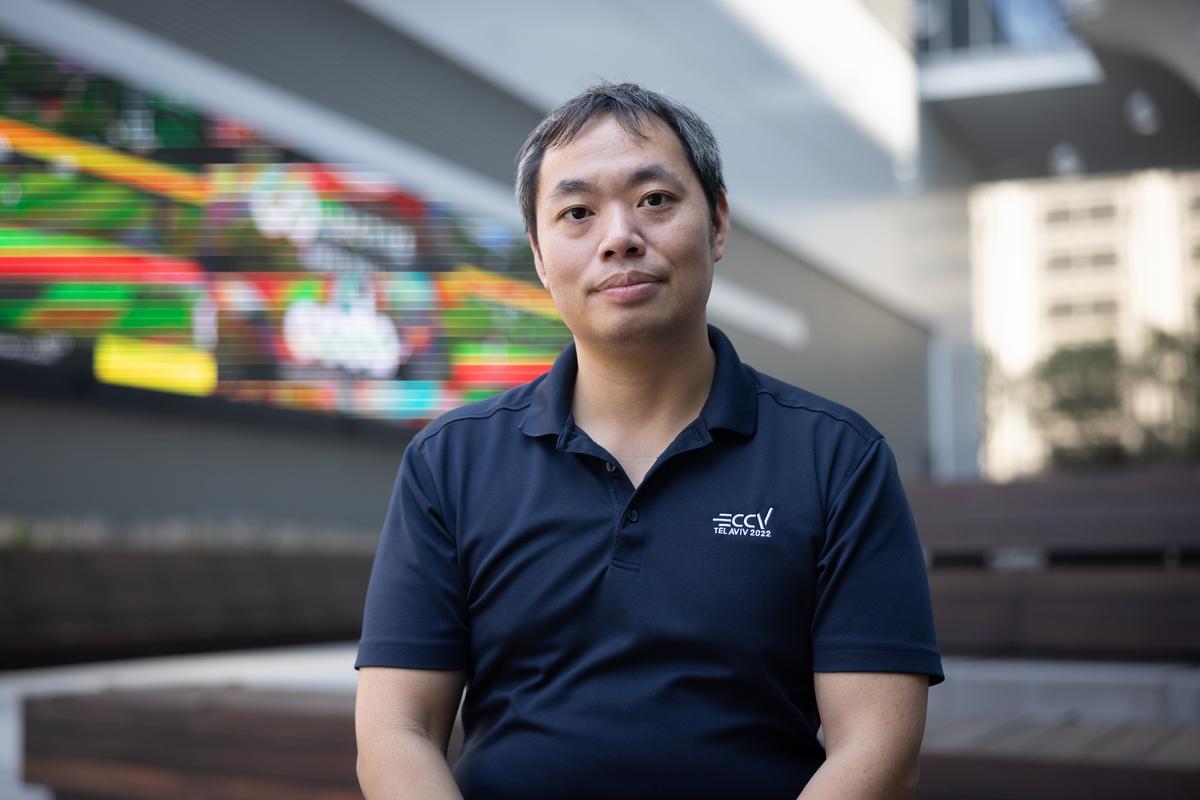 Faculty Member Humphrey Shi sitting in front of a screen.