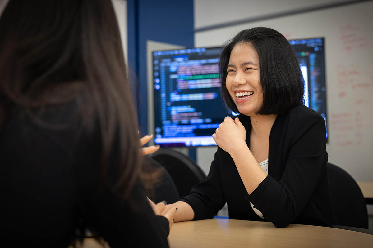 Professor Cindy Xiong talking to a colleague