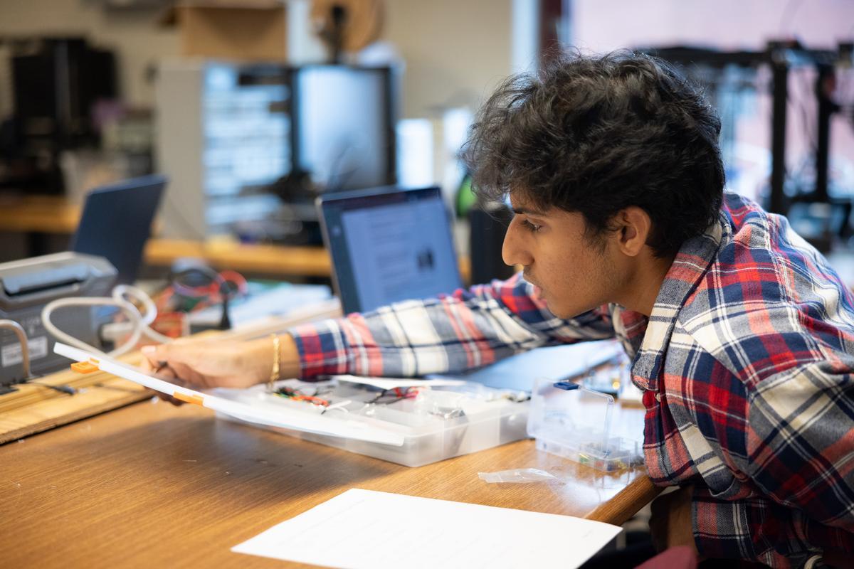 Student working with a piece of equipment.