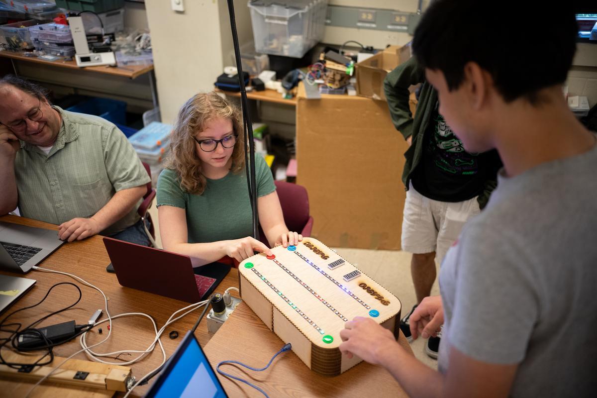 Students working on a device together