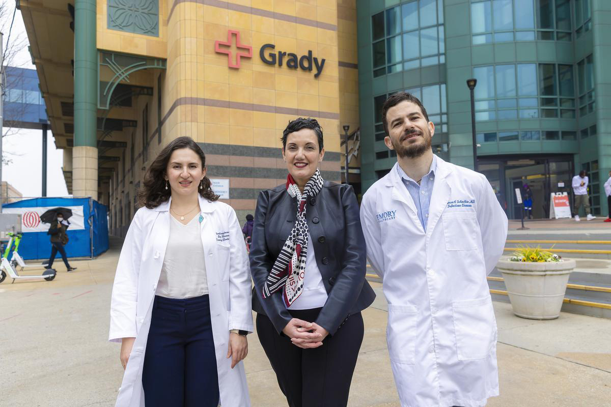 Faculty member with doctors at Grady Hospital