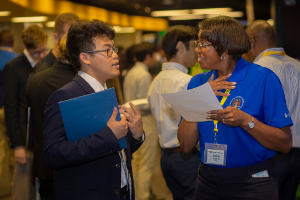 recruiter speaking with student at career fair