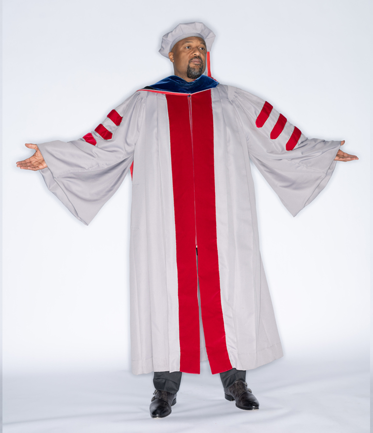 Charles Isbell spreading his arms in robe