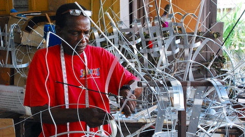 Artisan from Trinidad and Tobago creating wire frame by hand for elaborate Carnival costume
