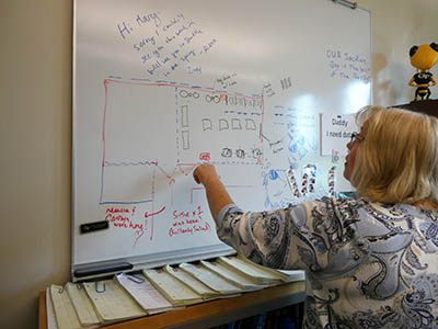 A blueprint of renovations remains on Hudachek-Buswell's whiteboard. 