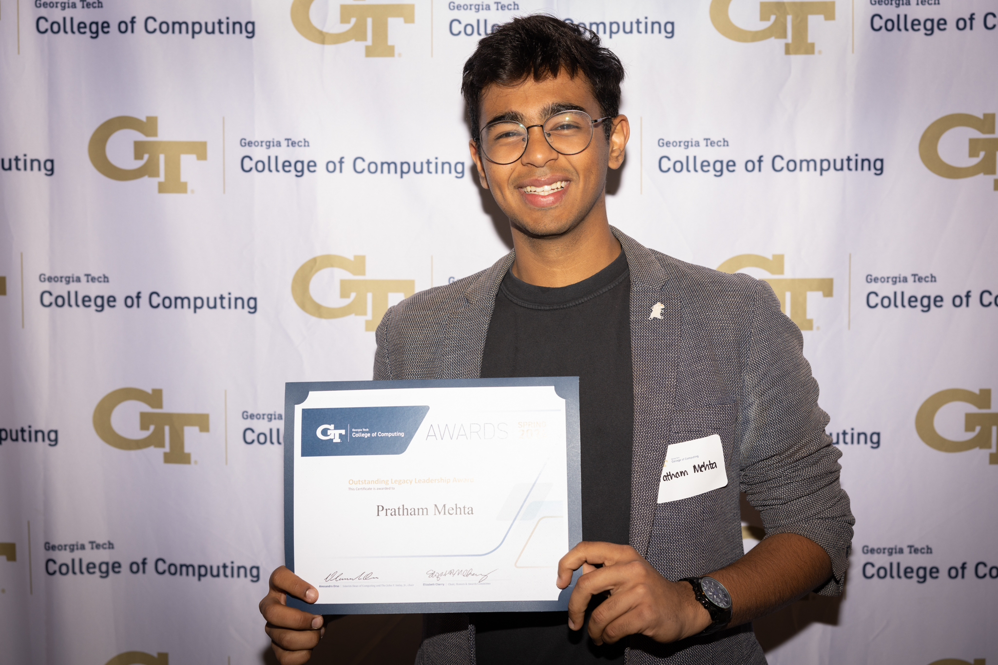 Pratham Mehta receives an award. Photo by Kevin Beasley/ College of Computing. 