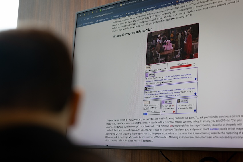 View of a screen over a man's shoulder