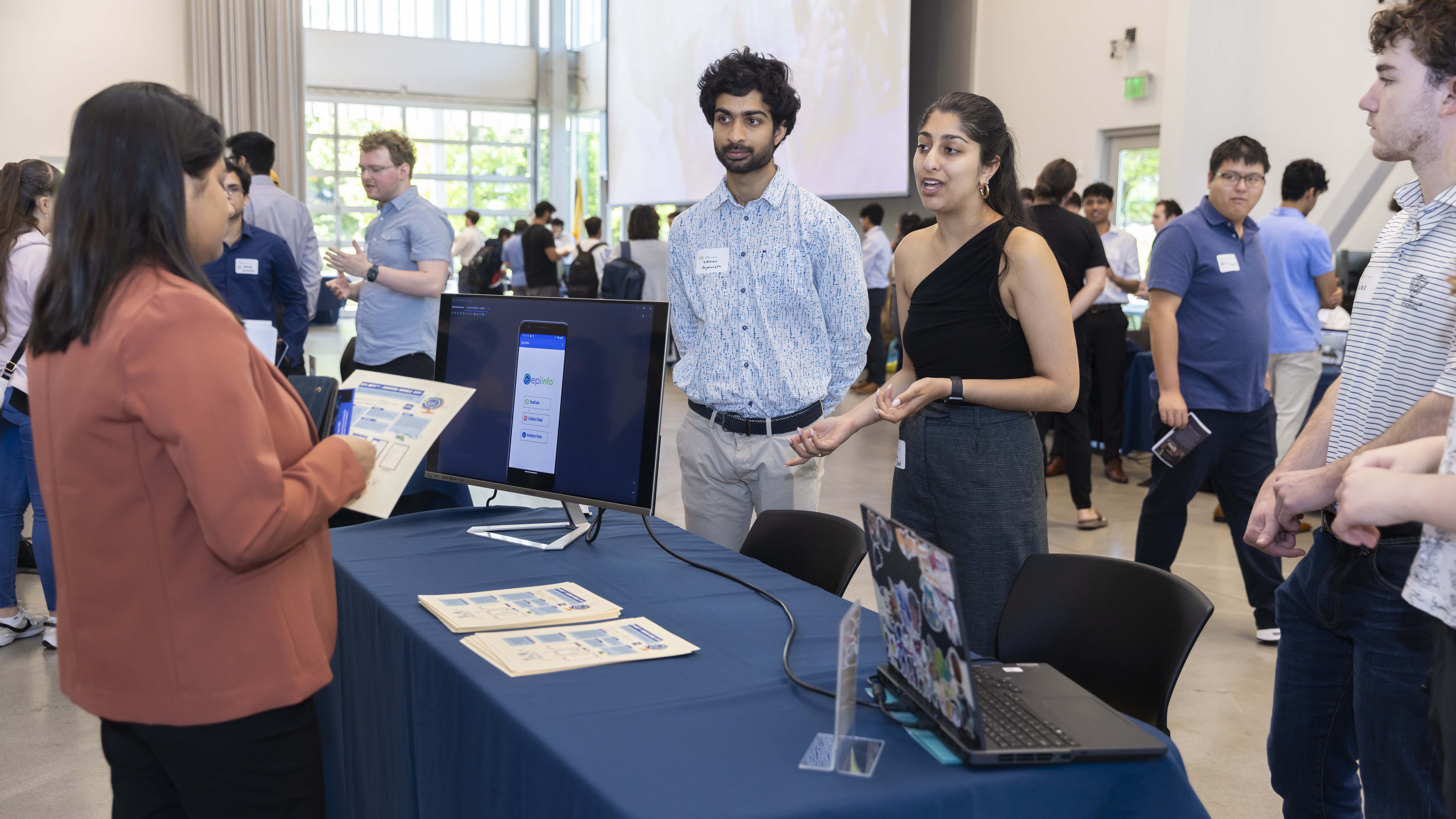 SCI's Nimisha Roy works with students at the Spring 2024 Capstone Expo. Photos by Terence Rushin.