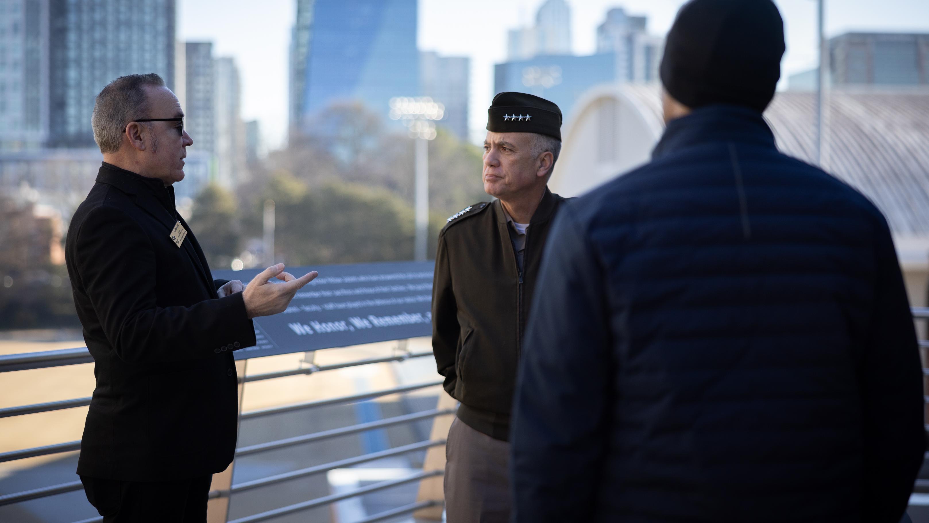 Two men speak outside