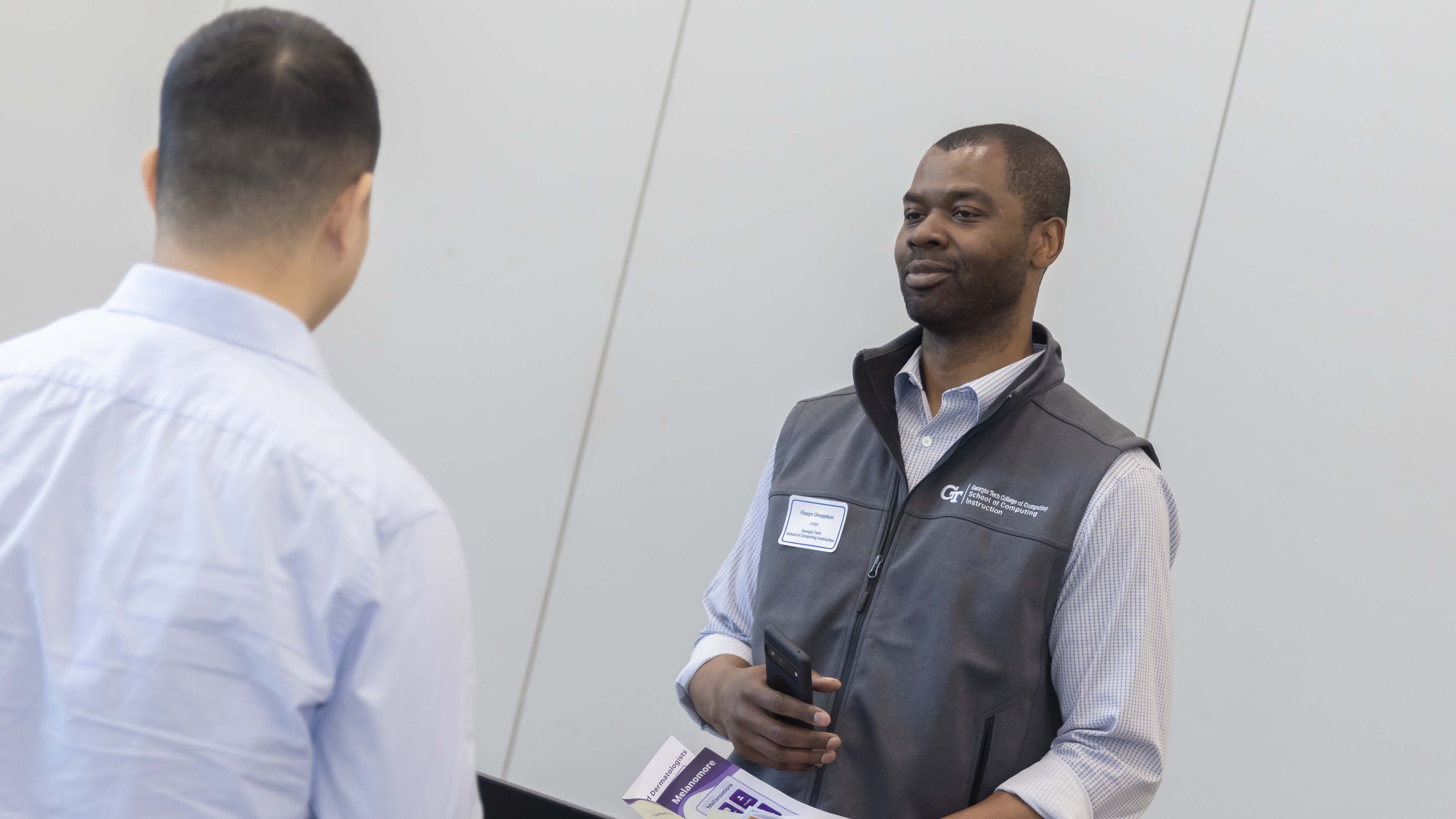 SCI Chair Olufisayo Omojokun judges student projects at the Capstone expo. Photos by Terence Rushin/ College of Computing.