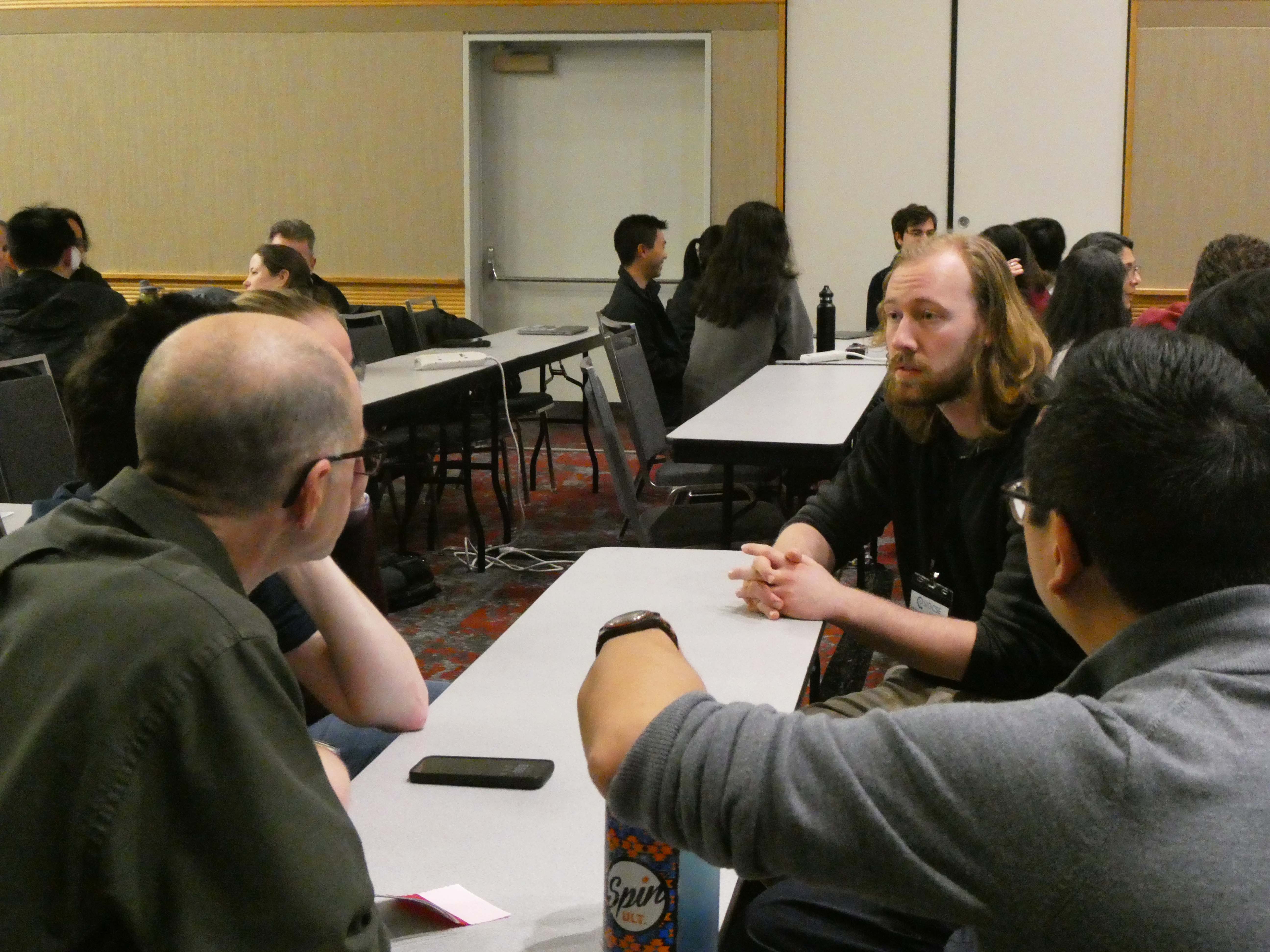 Attendees discuss their programs in small groups during the session. (Photos by Emily Smith/College of Computing)