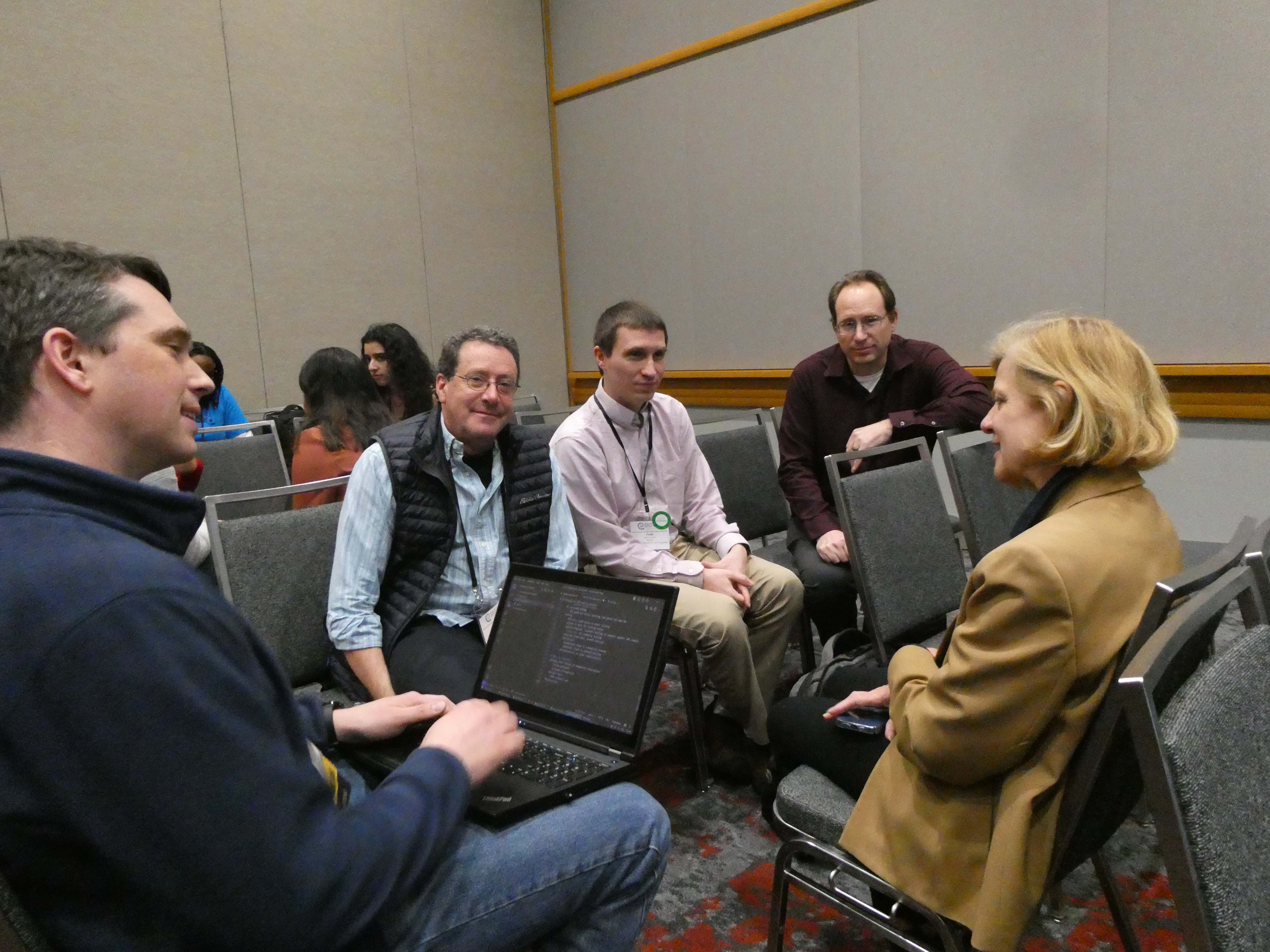 Attendees discuss their programs in small groups during the session. (Photos by Emily Smith/College of Computing)