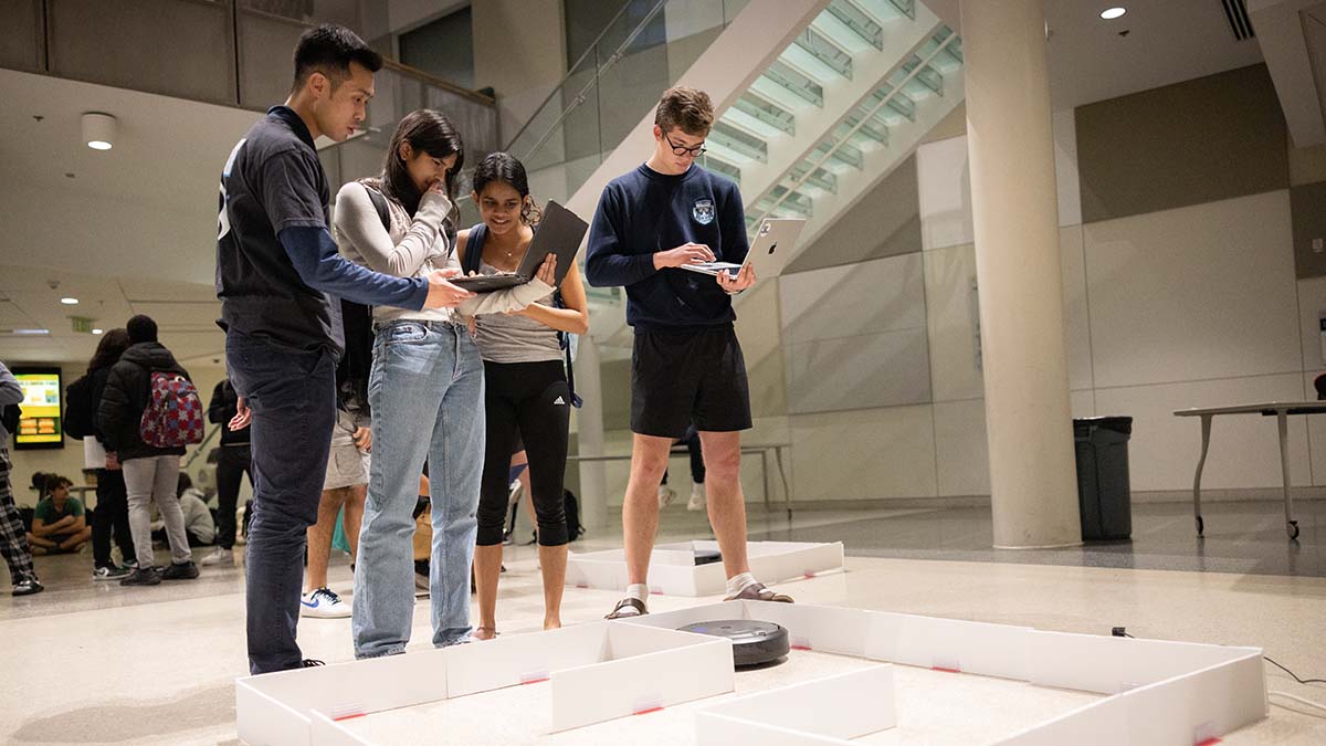 Students test code using robots.