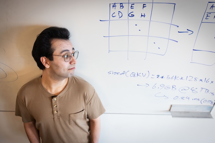 Ali Hassani next to whiteboard