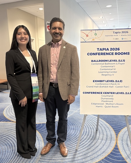 CS major Cindy Muniz posing with GT Computing Dean Vivek Sarkar at Tapia 2026 in Atlanta.