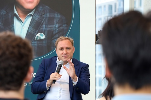 Candid photo of Georgia Tech alumnus  Dmitri Alperovitch listens to a student's question during a campus fireside chat in September 2025.