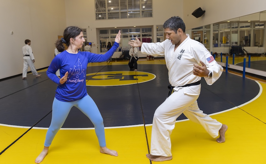 A female taido student works on technique with instructor Varun Agrawal