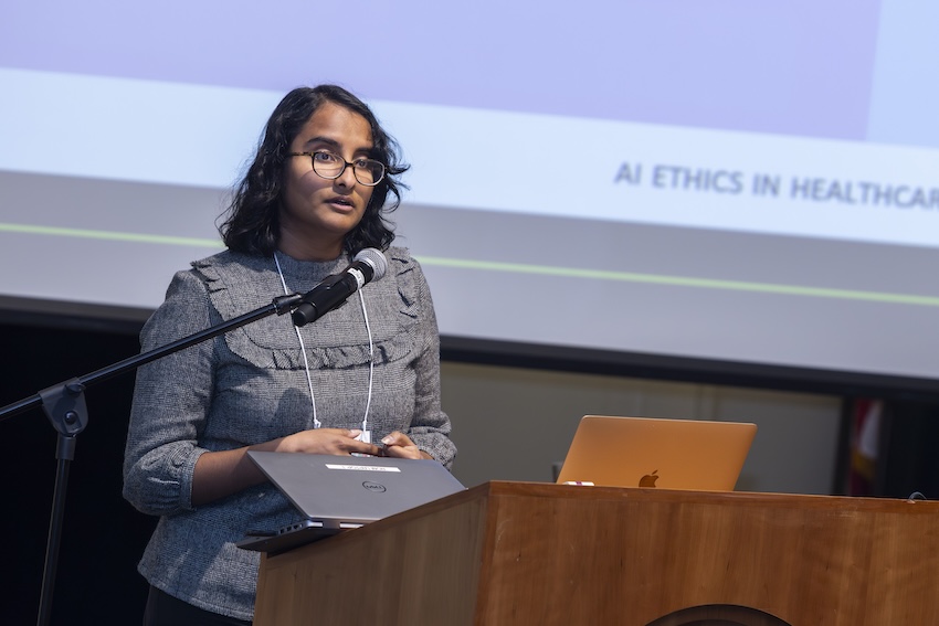 Naveena Karusala gives a presentation at a podium