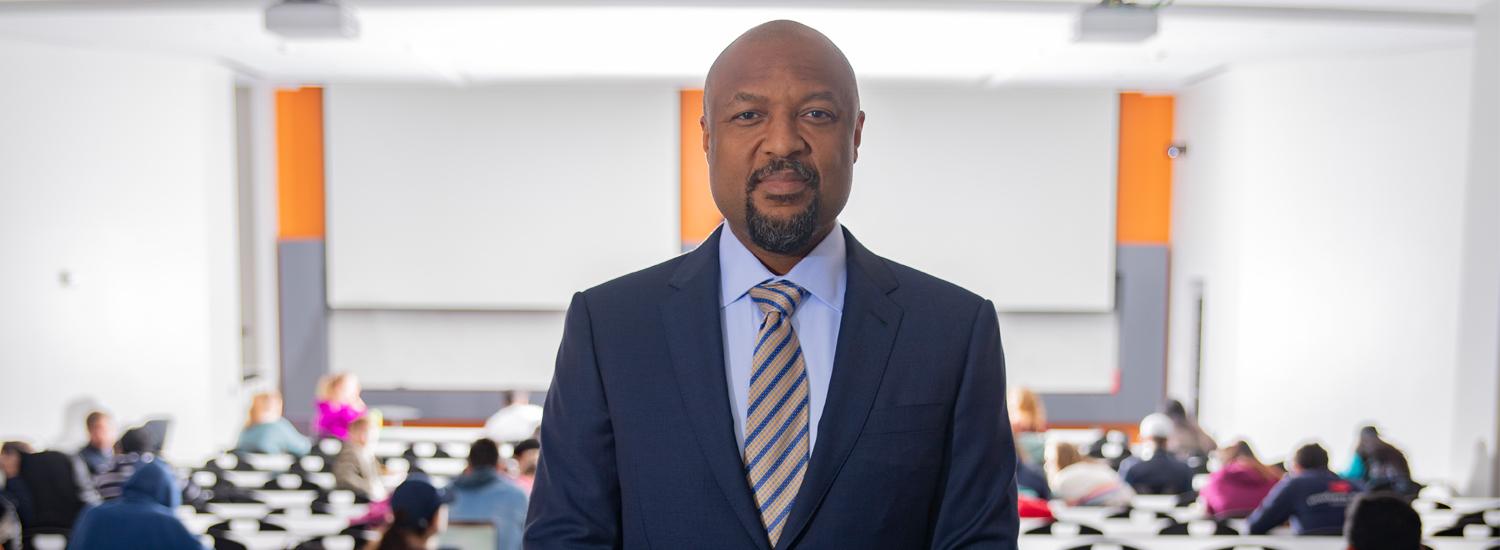 Charles Isbell standing in front of a classroom