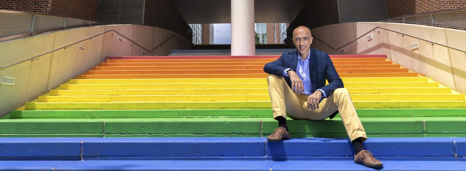 Interim Dean of Computing Alex Orso seated on Rainbow Steps at Georgia Tech