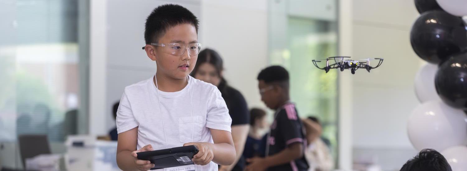 A child flying a drone