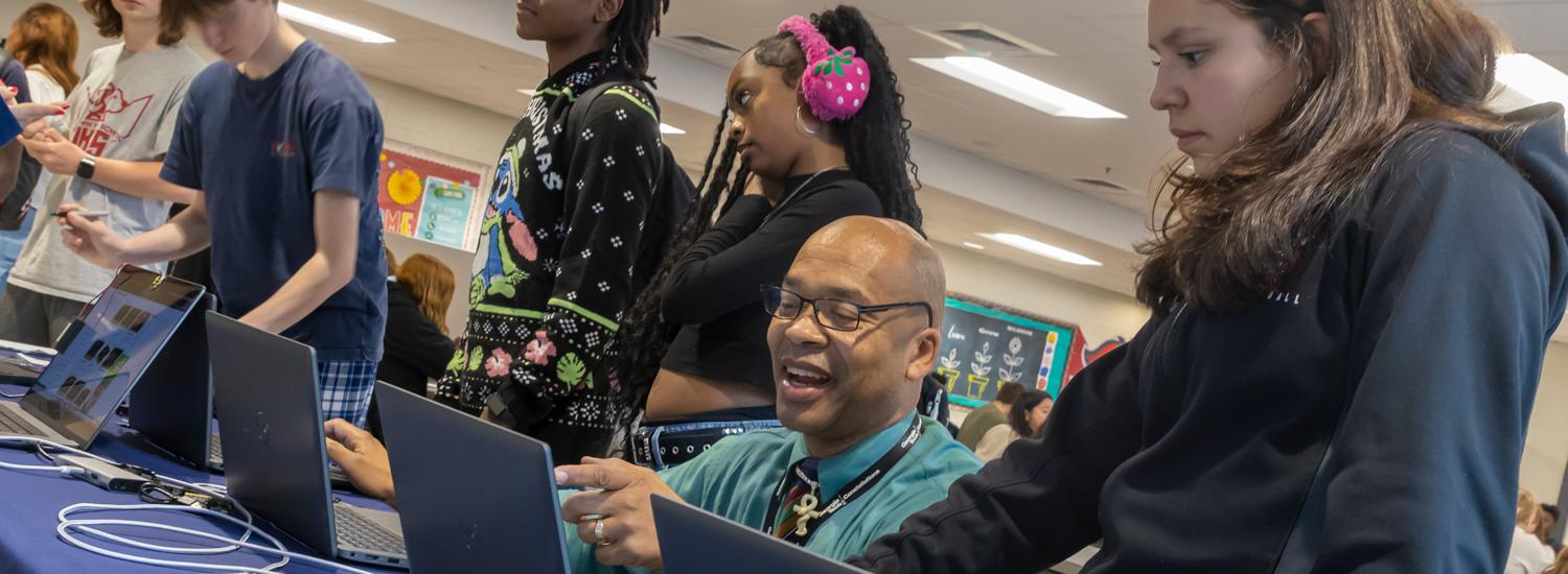 Georgia Tech staff member working with high school students.