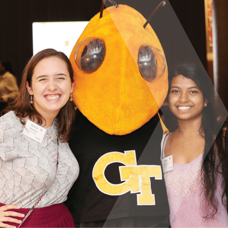 Two students hugging the Buzz mascot