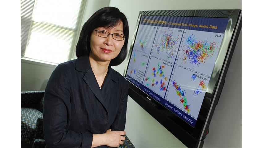 Headshot of Haesun Park in front of screen with data visualizations