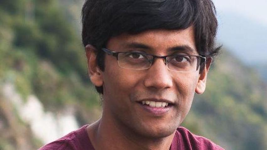 A man in glasses (Abhishek Das) smiling