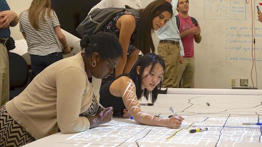 Two young women at Georgia Tech work together on data visualization project