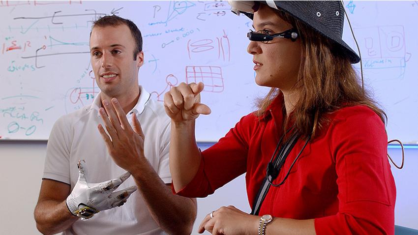 man and woman working with wearable technology