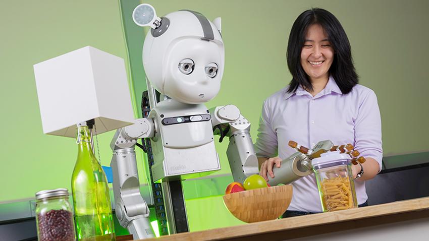 robot with woman picking up food