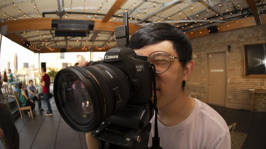 photographer looking through camera viewfinder