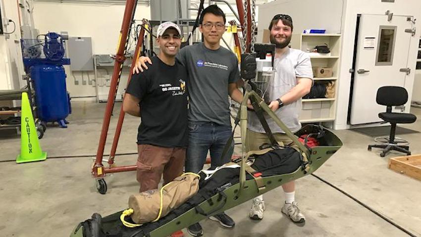 Computer science master's student Mahdi Al-Husseini, left, with the Stabilizing Aerial Loads Utility System he created with Stanford Ph.D. students (and Tech alums) Anthony Chen, center, and Joshua Barnett.