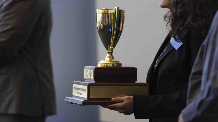 A woman holding a trophy 