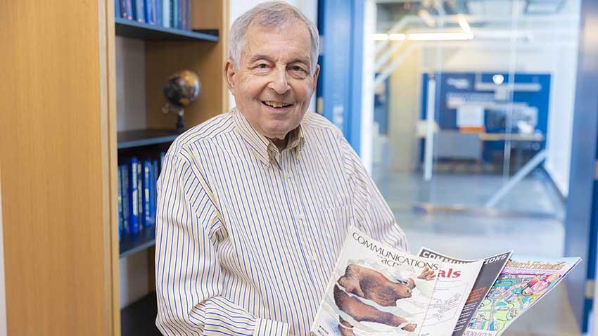 man holding booklets 