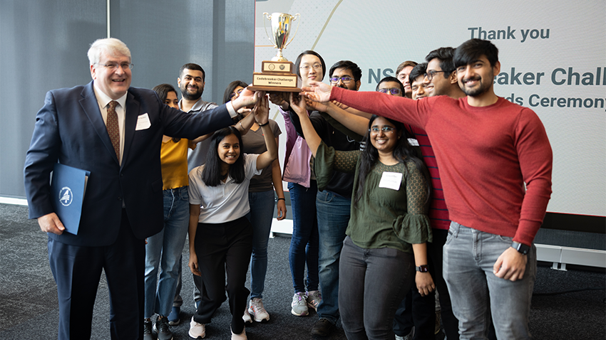 Group of people holding a trophy 