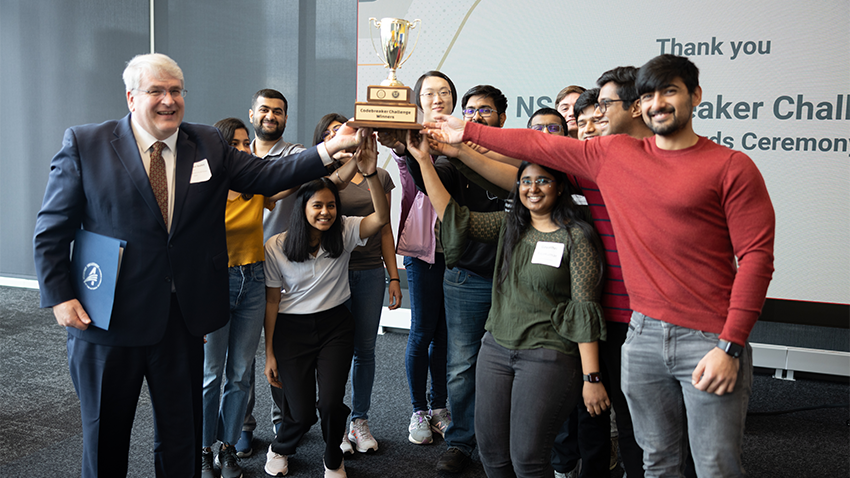 Group of people holding a trophy