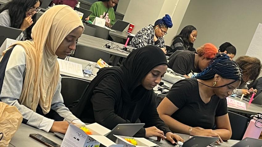 Young women working together on computing project at Georgia Tech