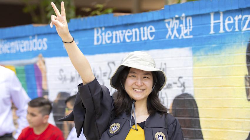 A new Georgia Tech OMSCS graduate smiles for a photo during a campus tour held on graduation weekend